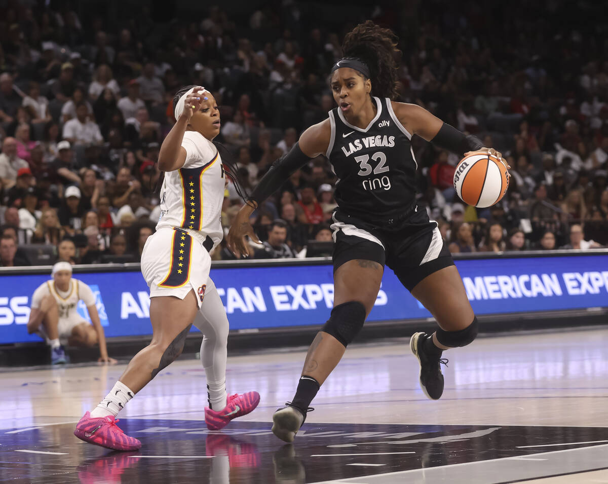 Aces forward Cheyenne Parker-Tyus (32) drives to the basket against Indiana Fever guard Odyssey ...