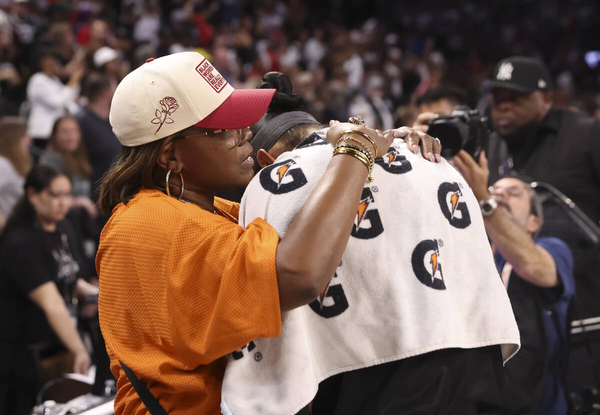 WNBA legend Sheryl Swoopes, left, talks with Aces center A'ja Wilson (22) after the Aces d ...