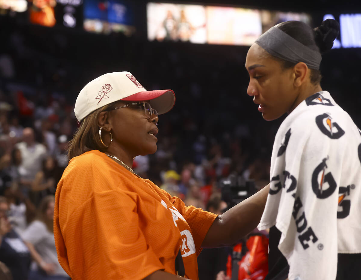 WNBA legend Sheryl Swoopes, left, talks with Aces center A'ja Wilson (22) after the Aces d ...