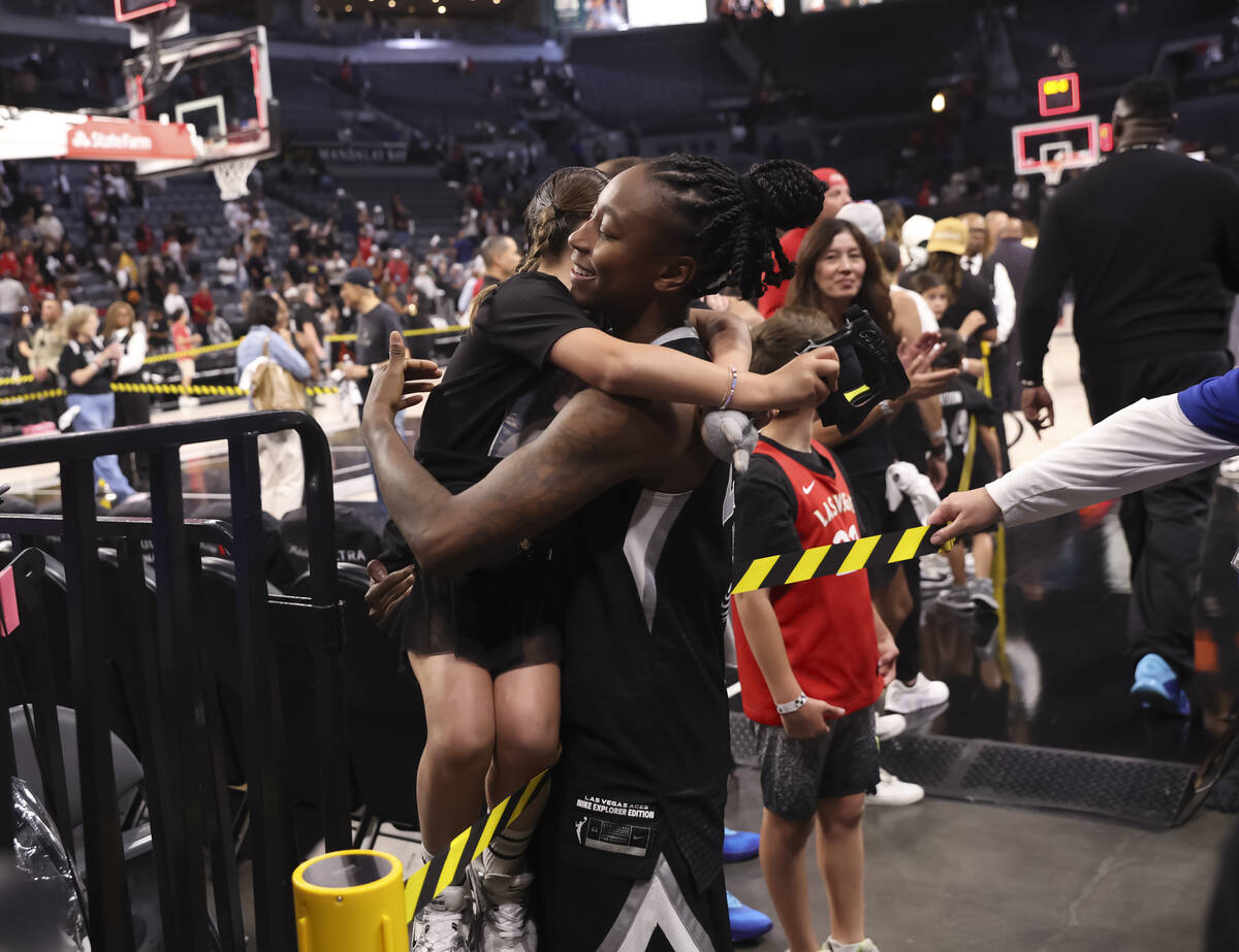 Aces guard Jewell Loyd hugs a young fan after the Aces defeated the Indiana Fever in Game 2 of ...