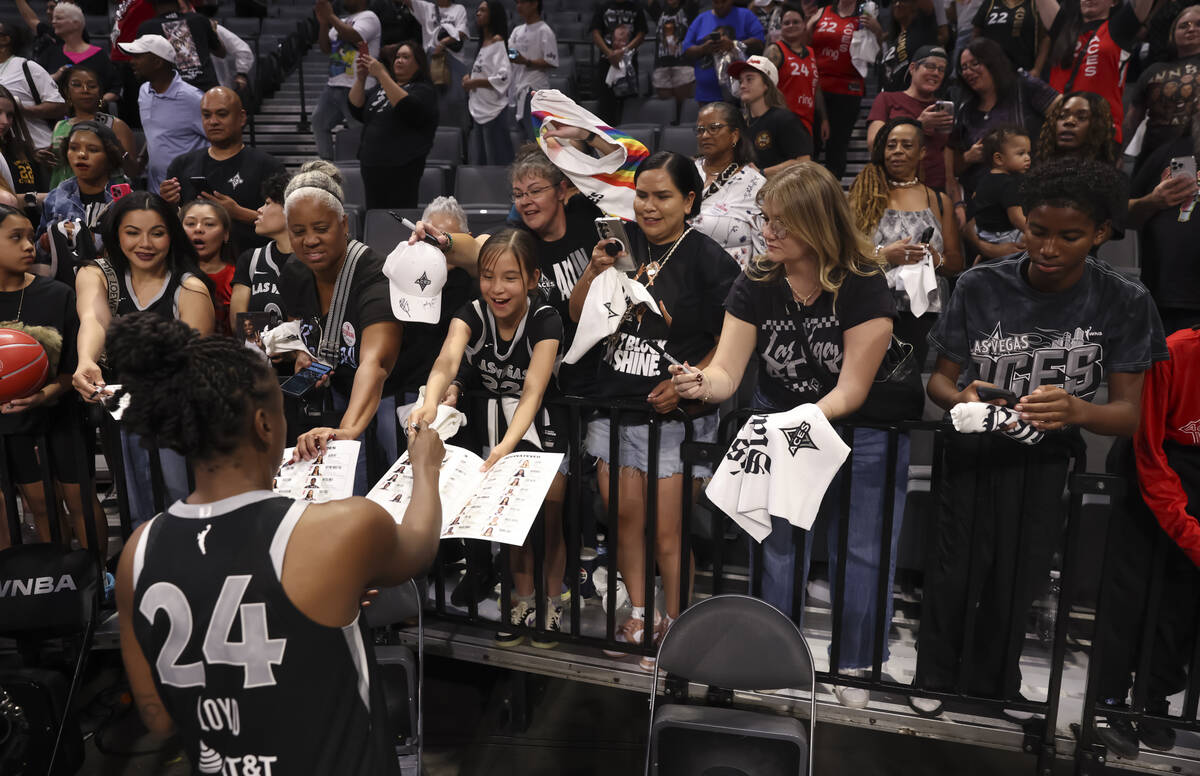 Aces guard Jewell Loyd signs items for fans after the Aces defeated the Indiana Fever in Game 2 ...