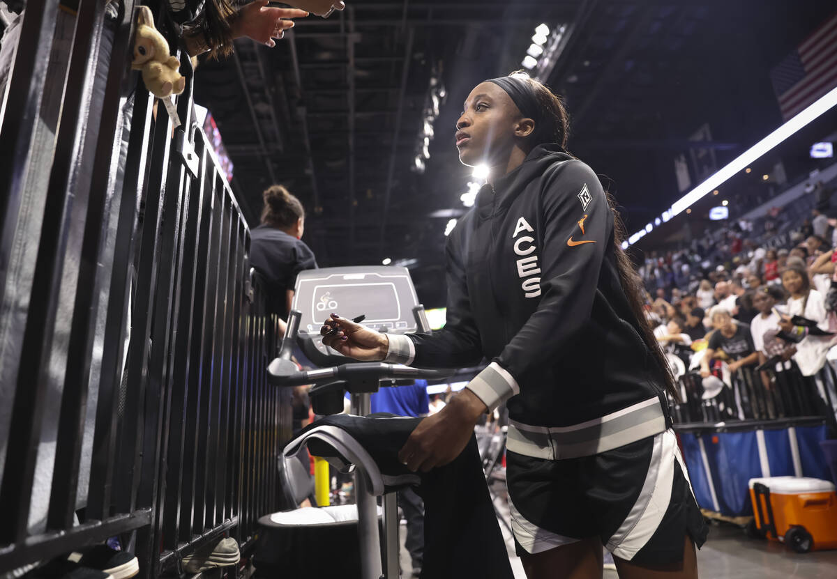 Aces guard Jackie Young signs items for fans after the Aces defeated the Indiana Fever in Game ...