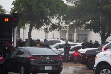 Law enforcement gather at a staging area close to a U.S. Immigration and Customs Enforcement of ...