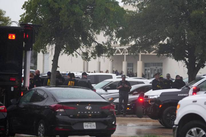 Law enforcement gather at a staging area close to a U.S. Immigration and Customs Enforcement of ...