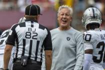 Raiders head coach Pete Carroll reacts during a conversation with back judge Jimmy Russell (82) ...