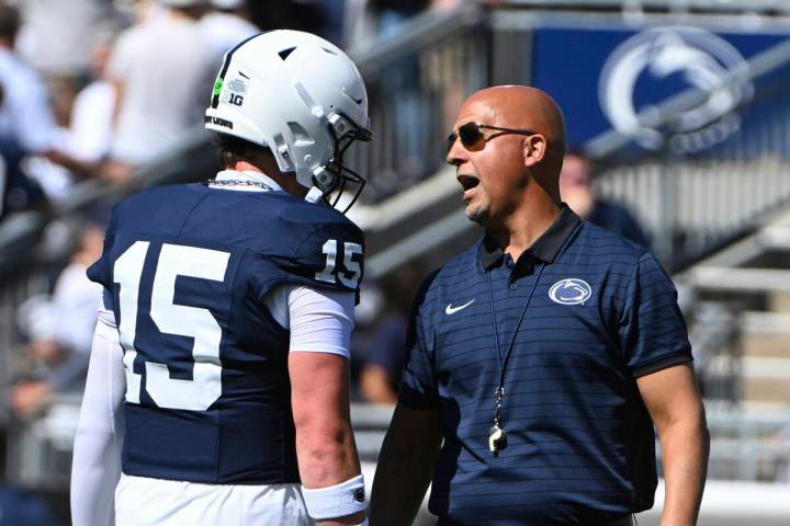 Penn State quarterback Drew Allar (15) talks with head coach James Franklin during warms up for ...