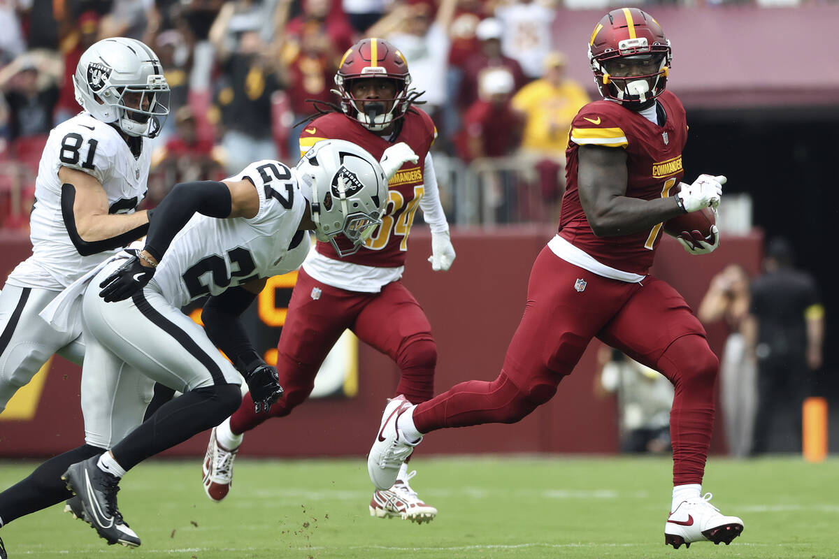 Washington Commanders wide receiver Deebo Samuel Sr. (1) runs with the ball during an NFL footb ...