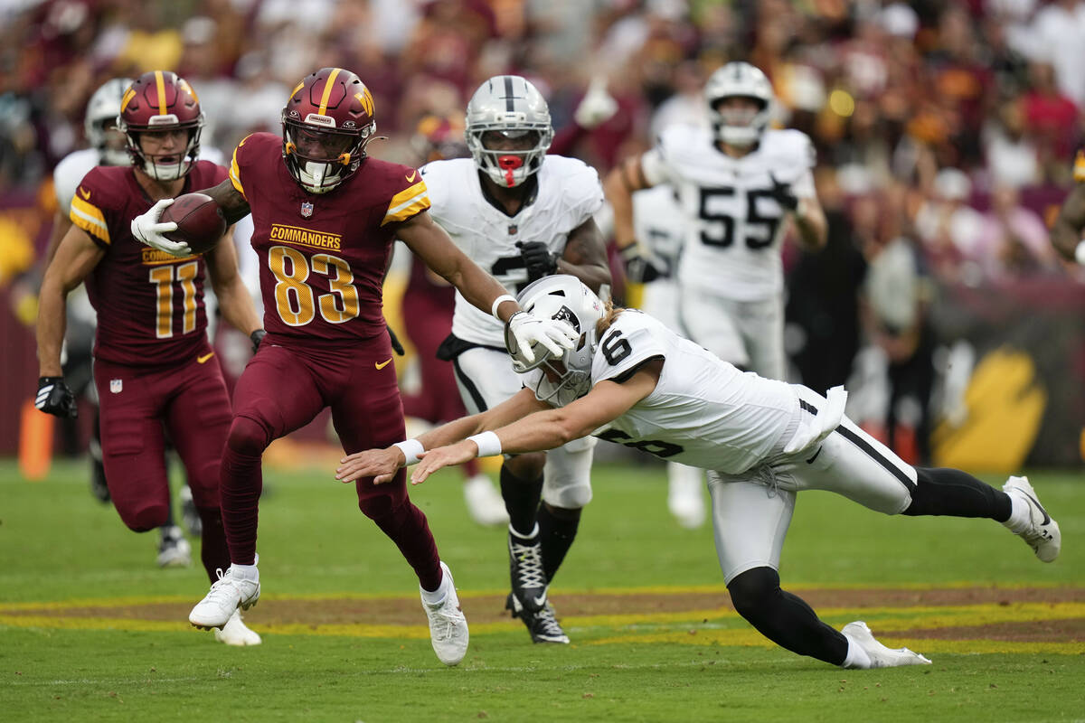 Las Vegas Raiders punter AJ Cole (6) tries to stop Washington Commanders wide receiver Jaylin L ...