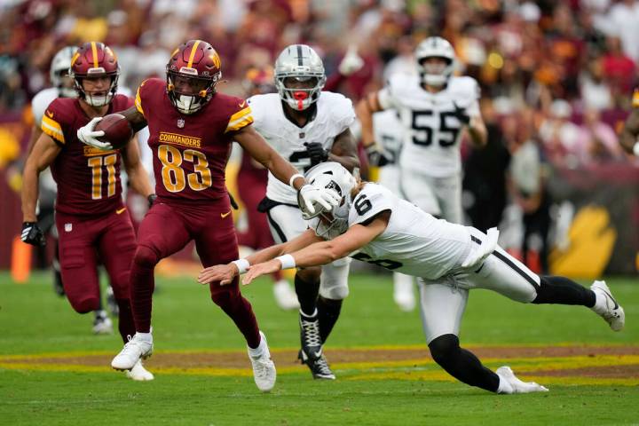 Las Vegas Raiders punter AJ Cole (6) tries to stop Washington Commanders wide receiver Jaylin L ...