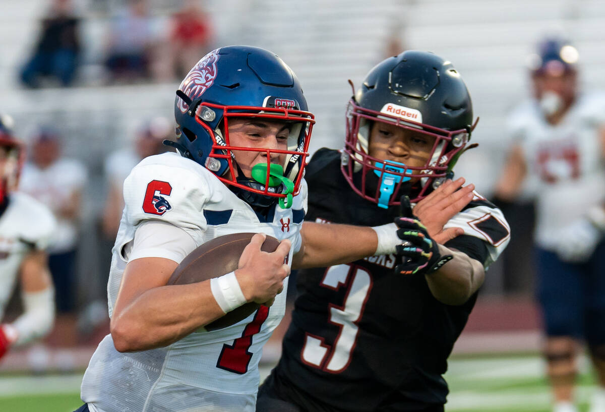 Coronado’s quarterback Jackson Humphries (1) holds back Desert Oasis's Eric Johnson ...