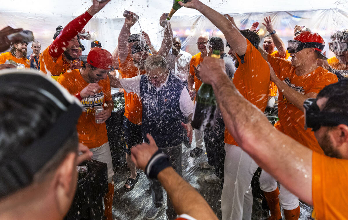 Don Logan, President and COO of the Las Vegas Aviators, is showered with champagne as he and th ...