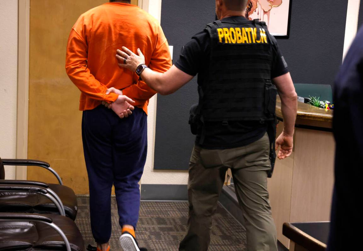 A juvenile suspected in casino cyberattack case is led out of Clark County Family Court after a ...