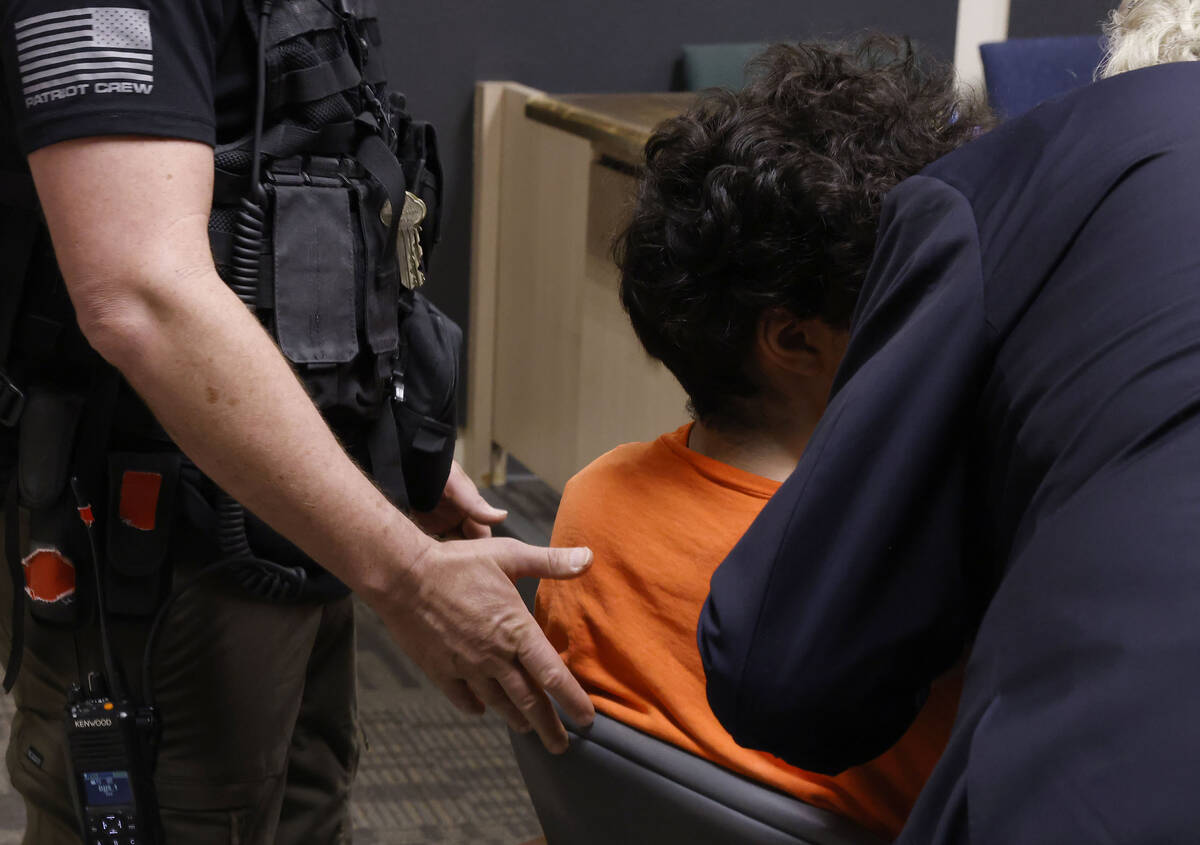 A juvenile charged in a casino cyberattack case listens to his attorney during a hearing in Cla ...