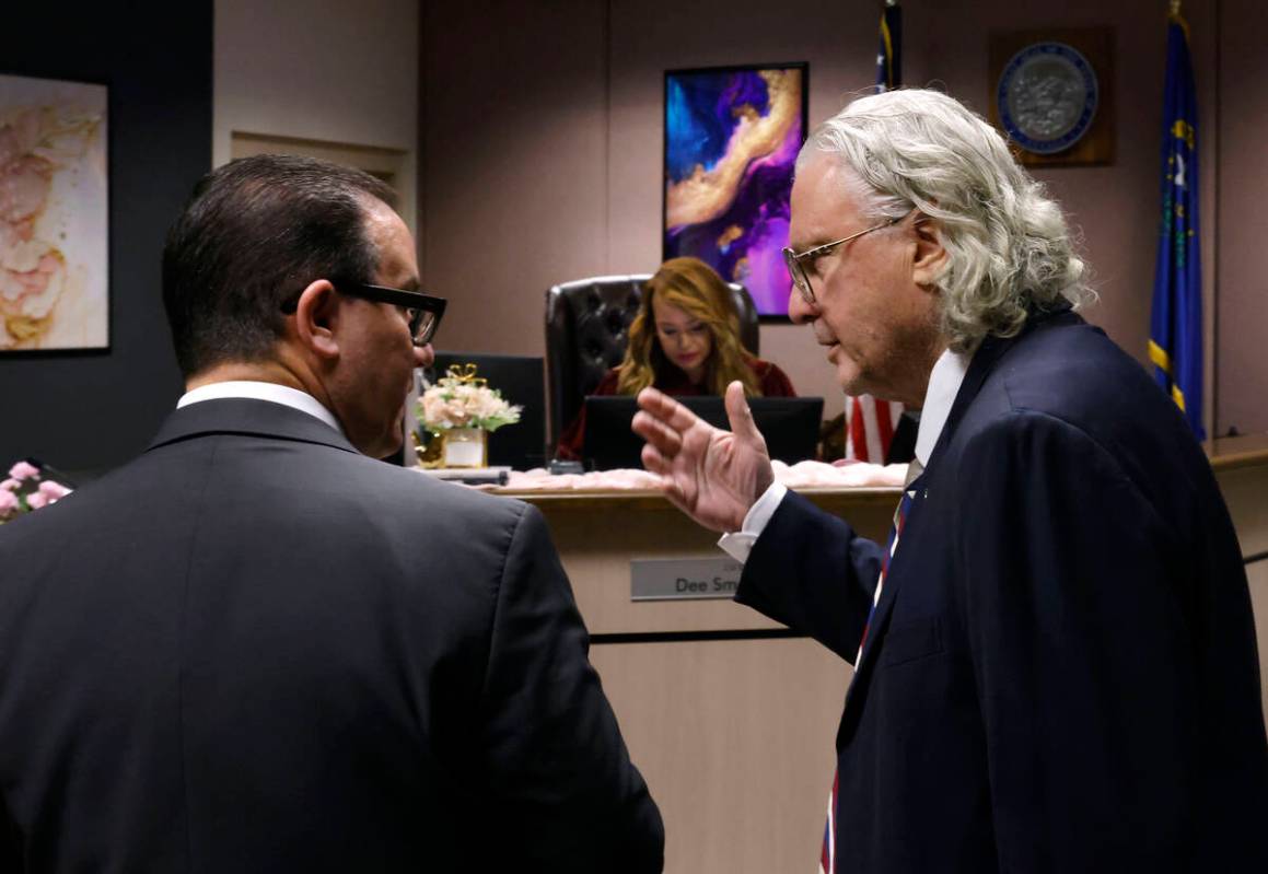 Attorneys Richard Schonfeld, left, and David Chesnoff confer during a hearing in Clark County F ...
