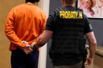 A juvenile suspected in casino cyberattack case is led out of Clark County Family Court after a ...