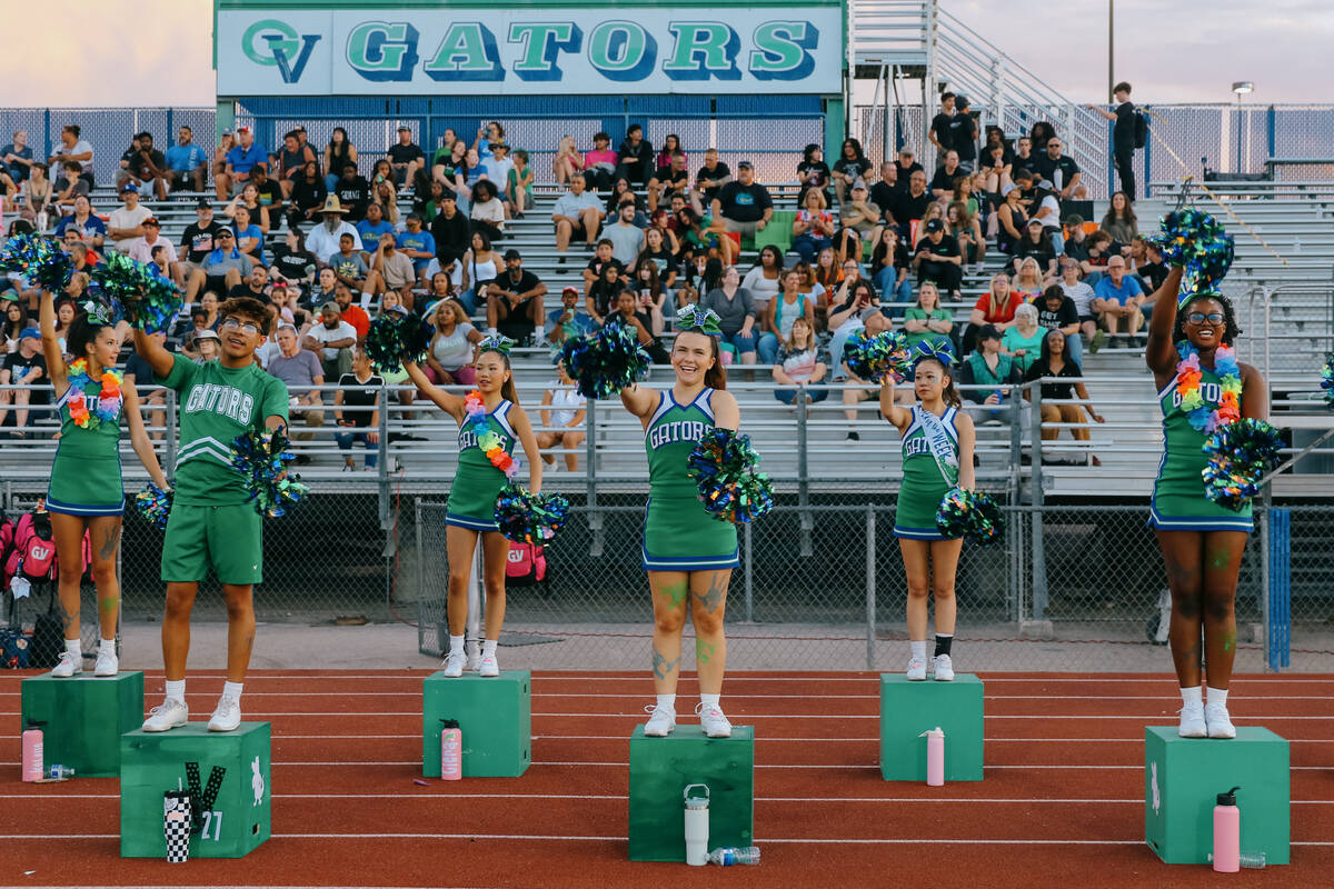 The Green Valley cheerleading team mimics the chomp of an alligator to cheer for the football t ...
