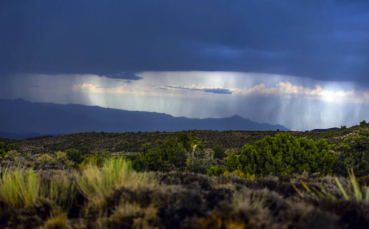 Rain falls on the Sheep Range beyond Lee Canyon as storms move through the area on Thursday, Ju ...