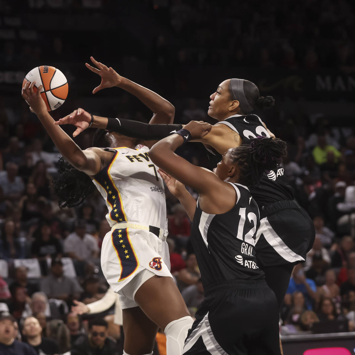Indiana Fever forward Aliyah Boston (7) tries to hold onto a rebound against Aces center A&#039 ...