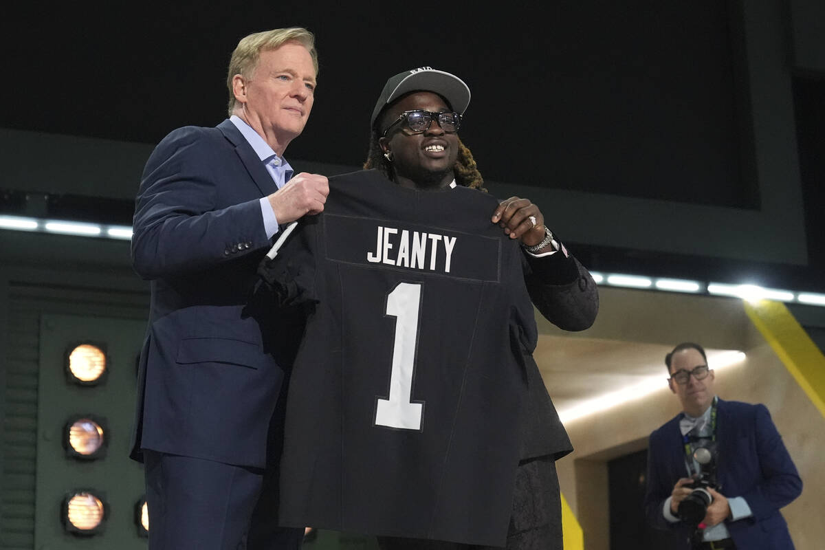 Boise State running back Ashton Jeanty, right, poses with NFL Commissioner Roger Goodell after ...