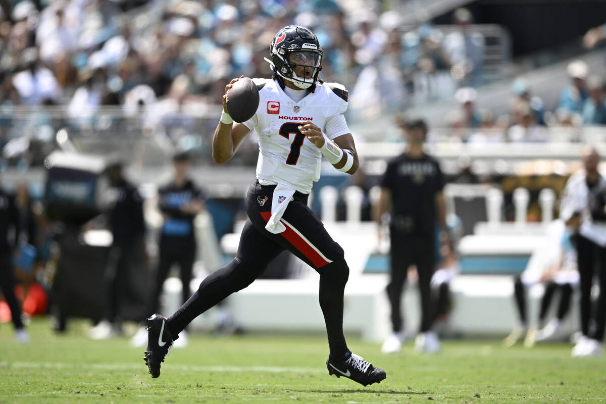 Houston Texans quarterback CJ. Stroud (7) looks for a receiver during the first half of an NFL ...