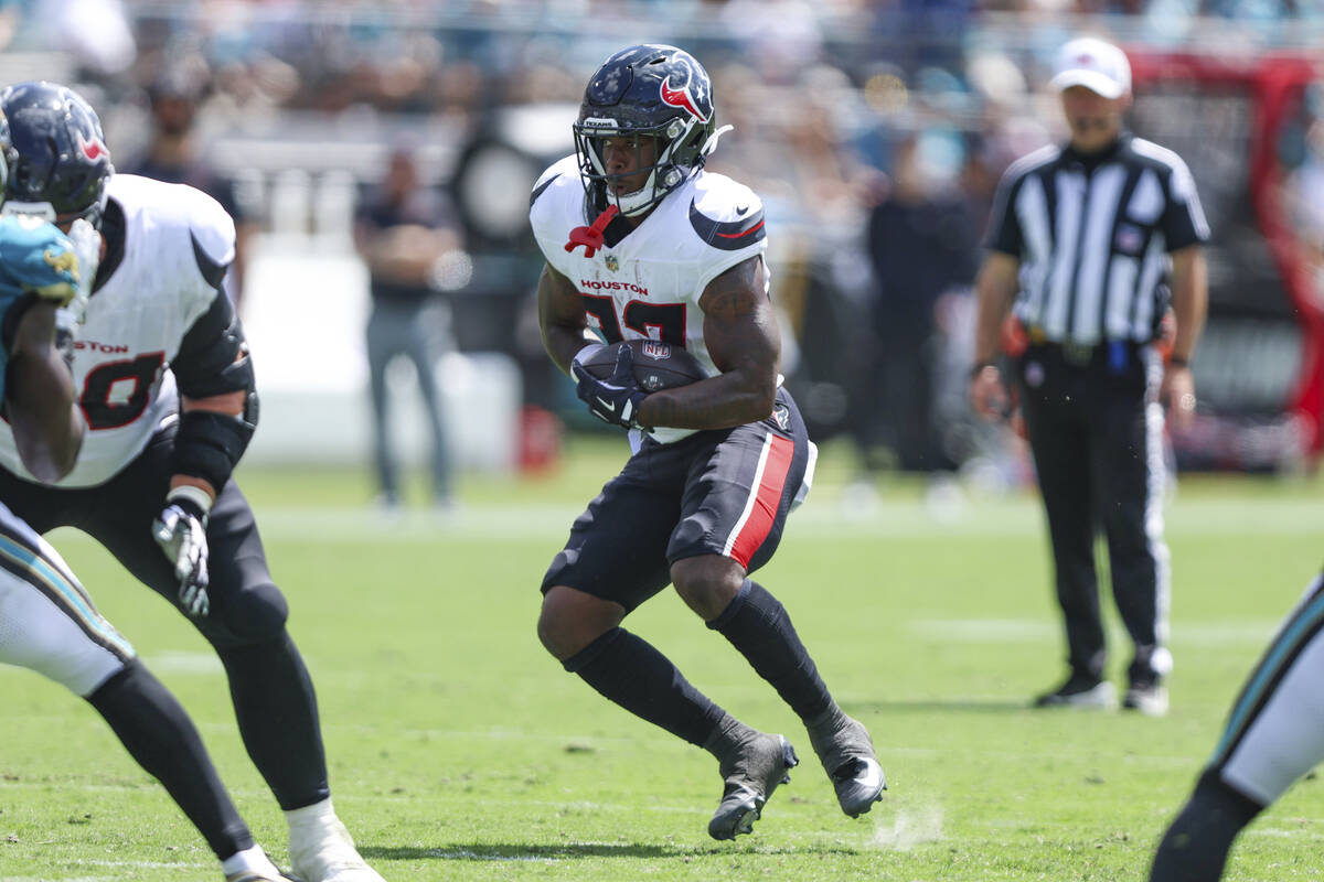 Houston Texans running back Woody Marks (27) runs the ball during an NFL football game against ...