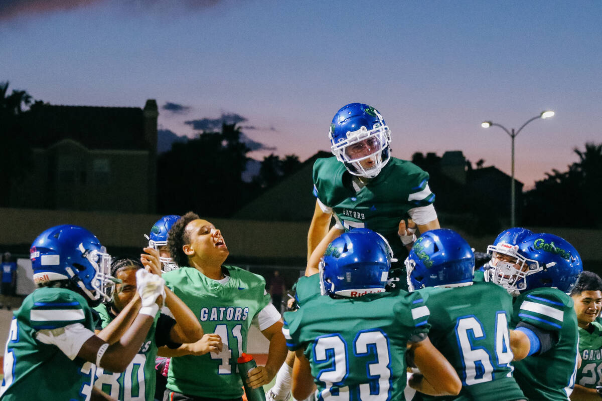 Green Valley players lift up Green Valley wide receiver/defensive back Sonny Uranich (7) after ...