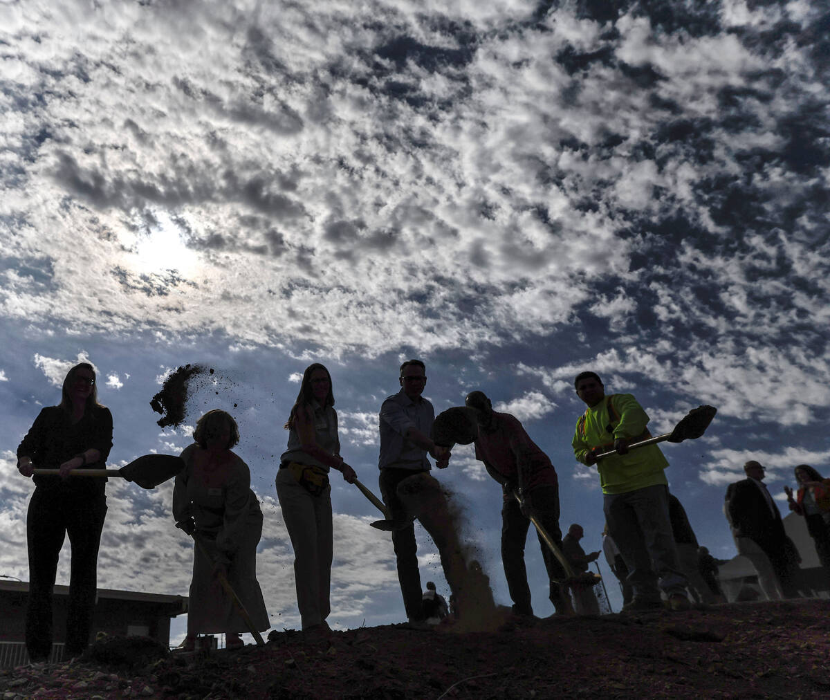 Distinguished guests shovel dirt during a groundbreaking event for the Nevada Adventure Center ...