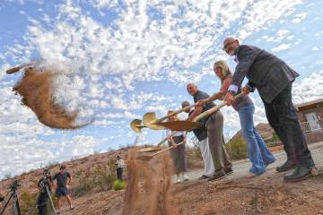 Rafael Villanueva, right, CEO of Travel Nevada, shovels dirt during a groundbreaking event for ...