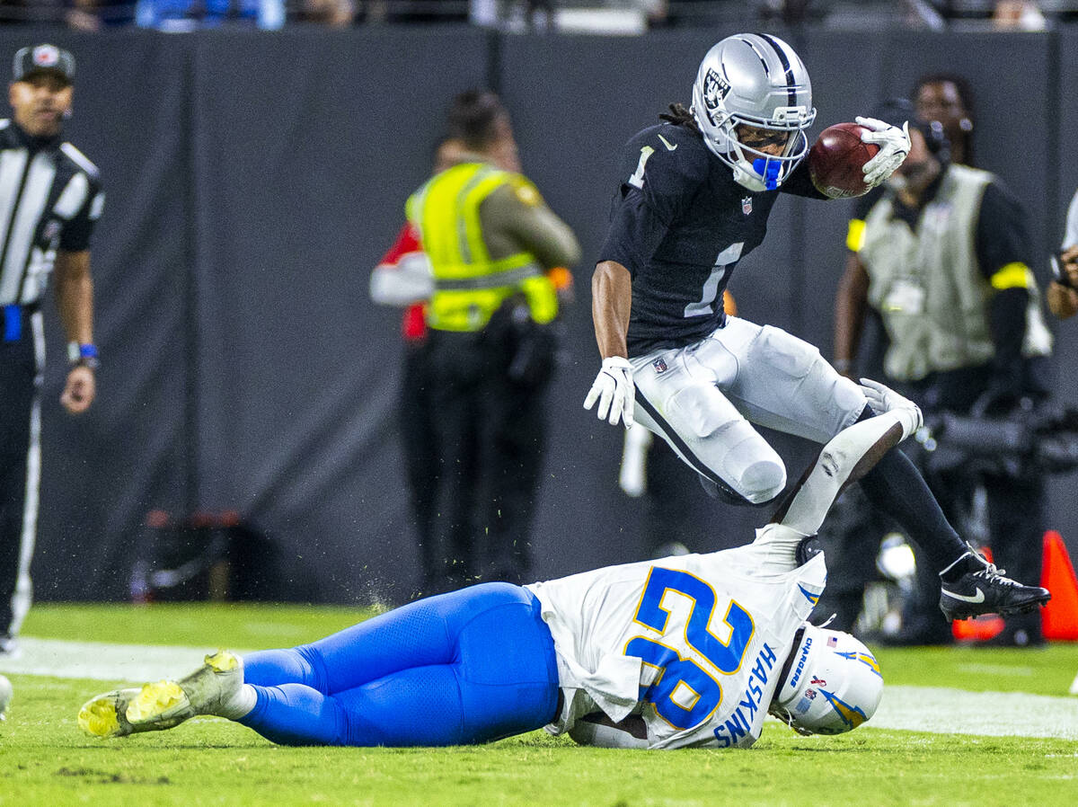 Raiders wide receiver Tre Tucker (1) attempts to hurtle Los Angeles Chargers running back Hassa ...
