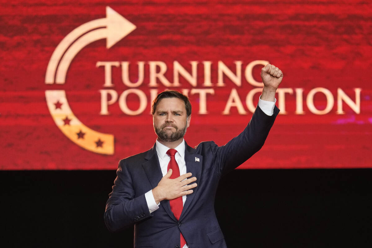 Vice President JD Vance holds his fist up as he leaves the stage after speaking at a memorial f ...
