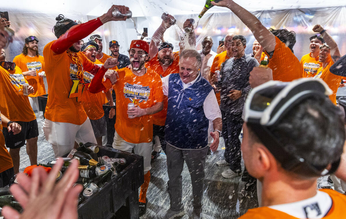 Don Logan, President and COO of the Las Vegas Aviators, is showered with champagne as he and th ...