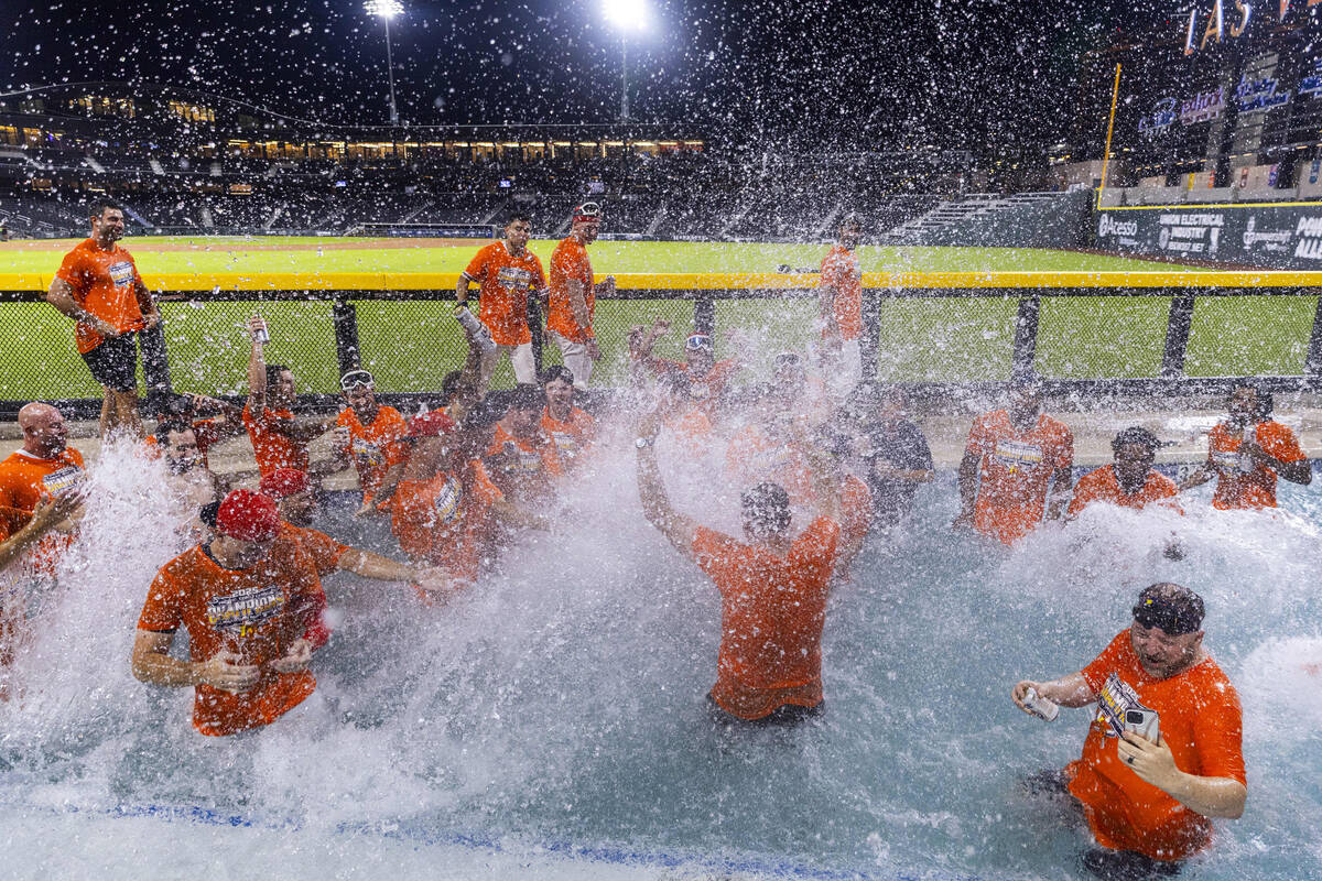 Aviators manager Fran Riordan jumps into the pool to join his players as they celebrate their w ...
