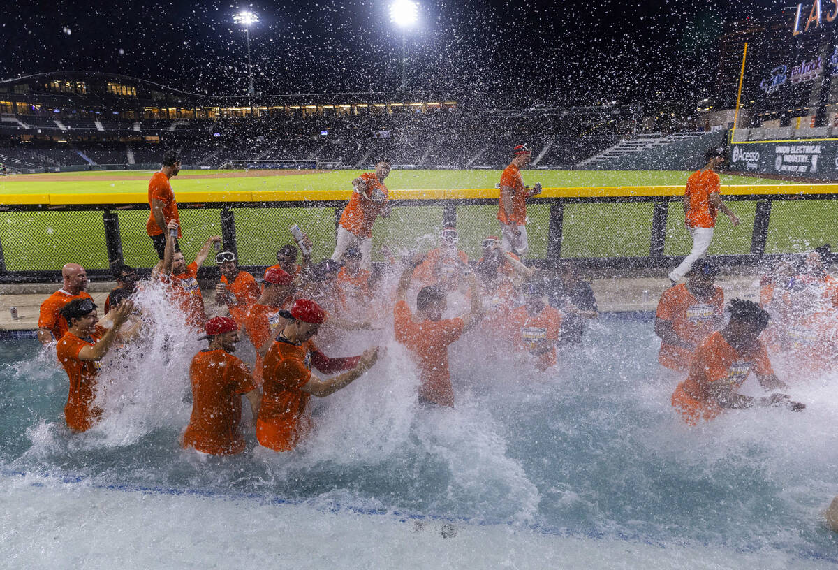 Aviators manager Fran Riordan jumps into the pool to join his players as they celebrate their w ...