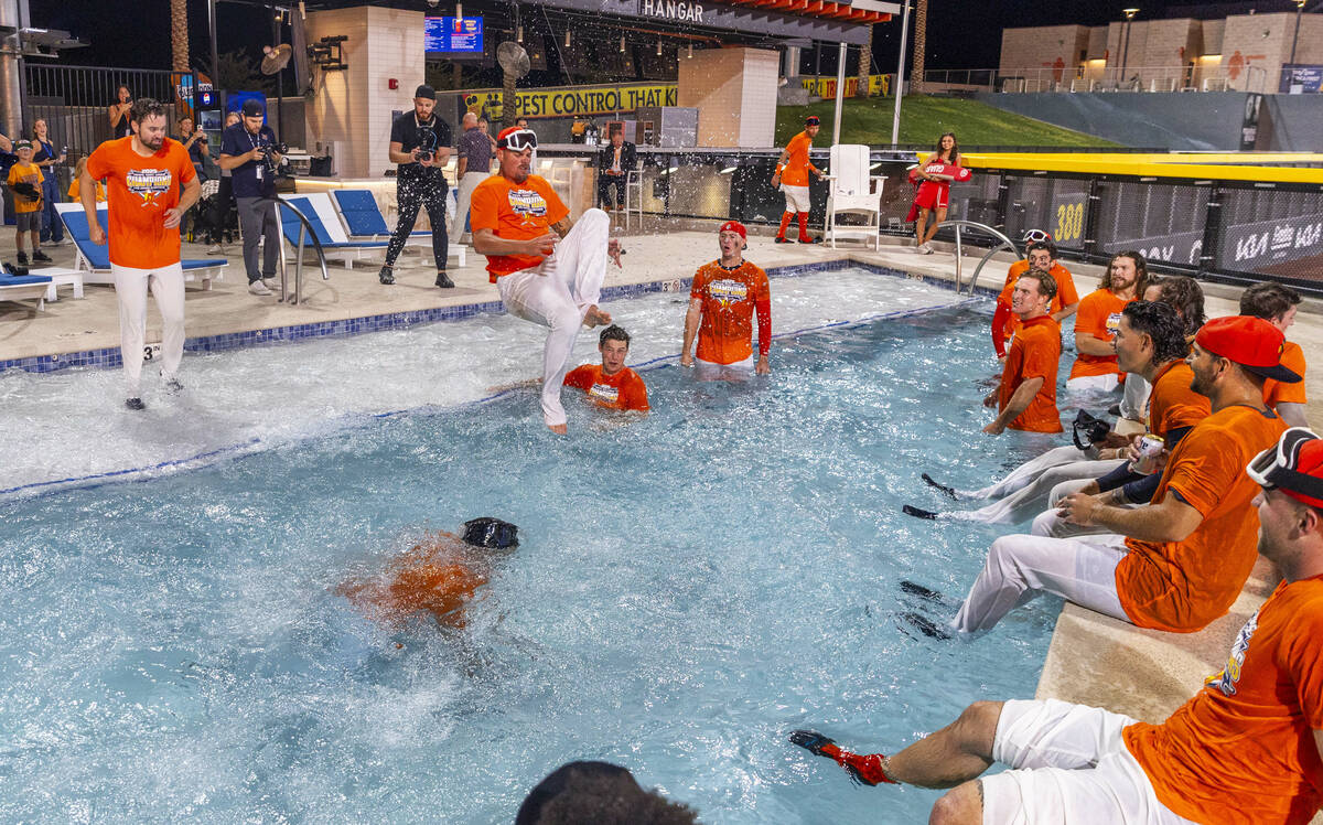 Aviators players jump into the outfield pool to celebrate their win over the Tacoma Rainiers 7- ...