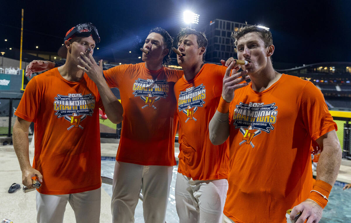 Aviators enjoy cigars about the outfield pool to celebrate their win over the Tacoma Rainiers 7 ...