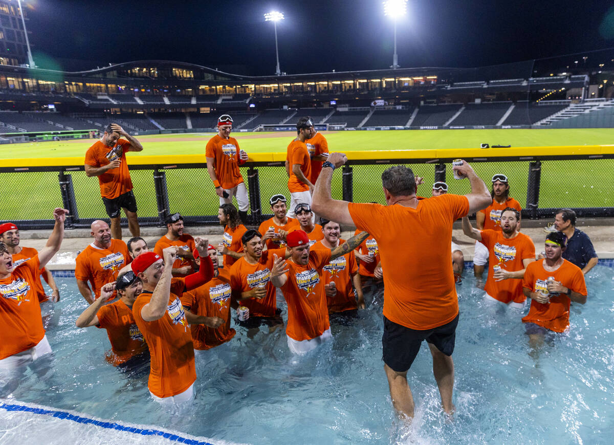 The Aviators manager Fran Riordan jumps into the pool to join his players as they celebrate the ...