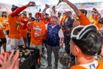 Don Logan, President and COO of the Las Vegas Aviators, is showered with champagne as he and th ...