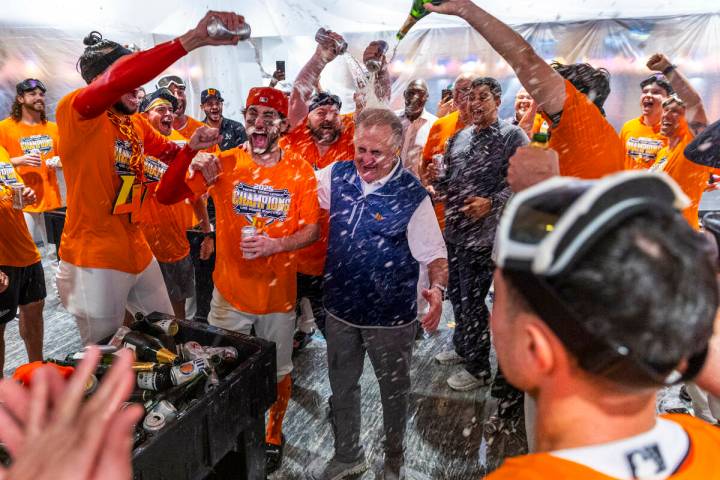 Don Logan, President and COO of the Las Vegas Aviators, is showered with champagne as he and th ...