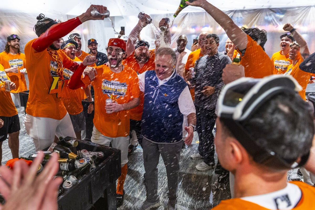 Don Logan, President and COO of the Las Vegas Aviators, is showered with champagne as he and th ...