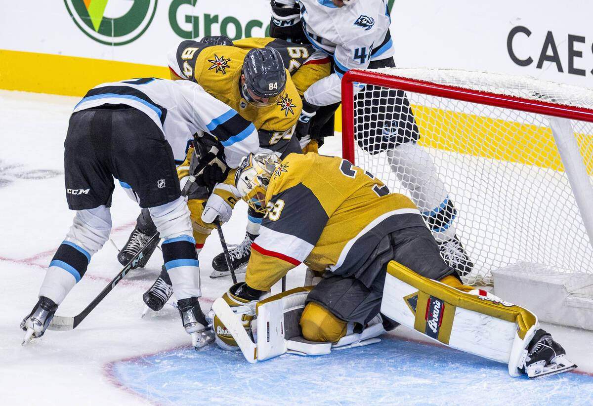 Golden Knights goaltender Adin Hill (33) smothers a shot by the Utah Mammoth during the first p ...