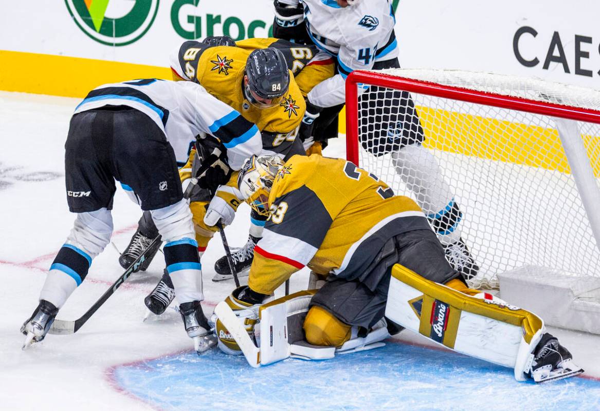 Golden Knights goaltender Adin Hill (33) smothers a shot by the Utah Mammoth during the first p ...