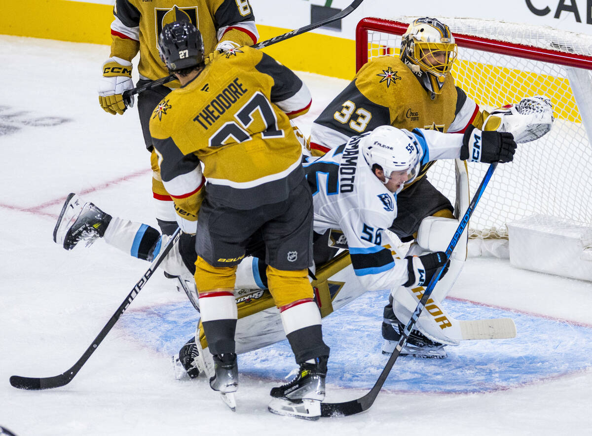 Utah Mammoth right wing Kailer Yamamoto (56) is wedged between Golden Knights defenseman Shea T ...