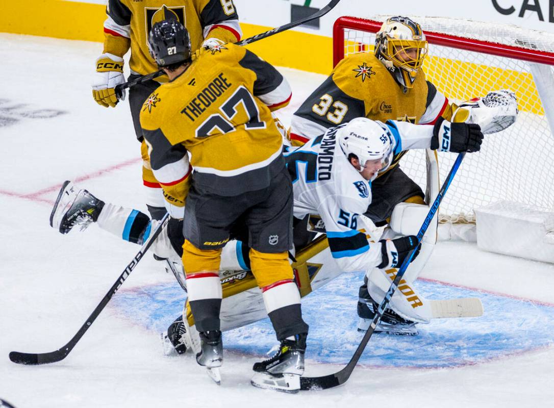 Utah Mammoth right wing Kailer Yamamoto (56) is wedged between Golden Knights defenseman Shea T ...