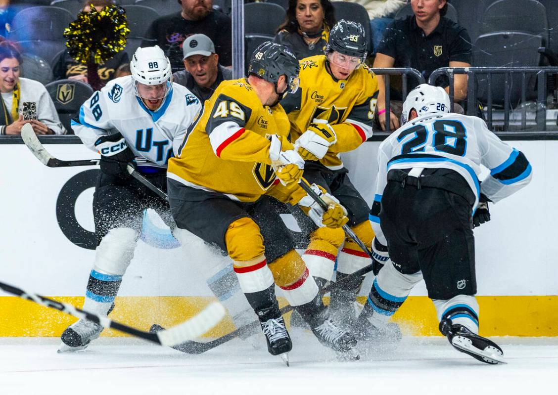 Utah Mammoth center Nick Schmaltz (88) battles for a puck with Golden Knights left wing Ivan Ba ...