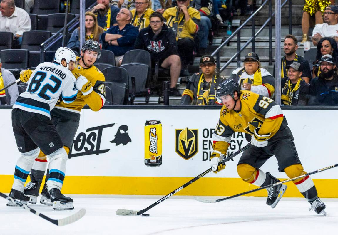 Golden Knights right wing Mitch Marner (93) looks to pass as left wing Ivan Barbashev (49) is t ...