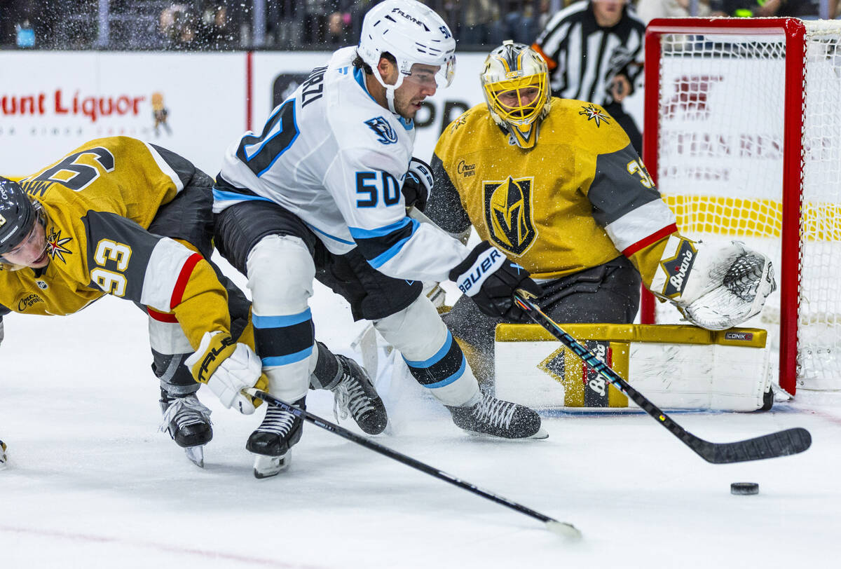 Golden Knights right wing Mitch Marner (93) looks to take the puck from Utah Mammoth defenseman ...