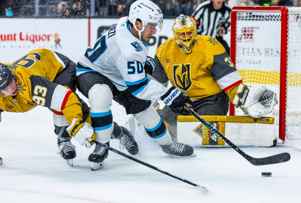 Golden Knights right wing Mitch Marner (93) looks to take the puck from Utah Mammoth defenseman ...