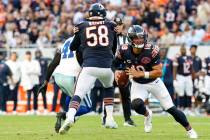 Chicago Bears quarterback Caleb Williams (18) runs with the ball during the second half of an N ...