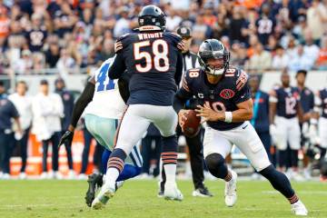 Chicago Bears quarterback Caleb Williams (18) runs with the ball during the second half of an N ...