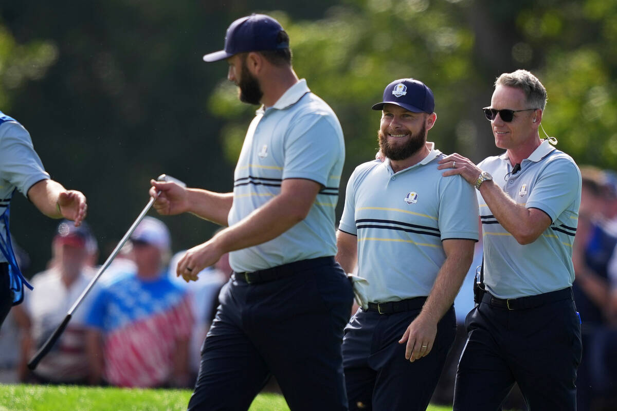 Europe's Jon Rahm, Tyrrell Hatton and captain Luke Donald walk down on the 11th hole at Be ...